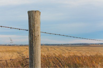 fence-post-prairie-landscape-bokeh-260nw-294413711.jpg