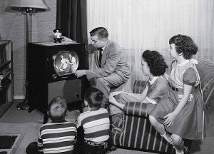 parents-with-three-children-watching-television.jpg
